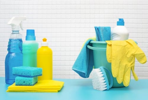 Close detail of a deep cleaning pass on a bathroom surface by a professional cleaner